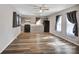 Open concept living room and kitchen area with wood-look flooring and lots of natural light at 329 W Red Cross Rd, Oakboro, NC 28129