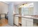 Bathroom with double sinks, granite countertops, and updated lighting with a shower in the background at 353 Whippoorwill Rd, Mooresville, NC 28117