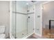 Bright bathroom with a glass-enclosed shower and a tiled surround with decorative border at 353 Whippoorwill Rd, Mooresville, NC 28117