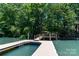 Dock with access to the lake and a boat lift for easy boat storage and maintenance at 353 Whippoorwill Rd, Mooresville, NC 28117
