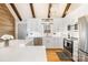 Well-lit kitchen with white cabinets, stainless steel appliances, and a large island at 353 Whippoorwill Rd, Mooresville, NC 28117