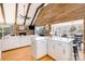 Open living room with wood-burning fireplace and island with counter seating at 353 Whippoorwill Rd, Mooresville, NC 28117