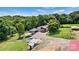 Picturesque aerial view showcasing a home, metal building, round pool, sheds surrounded by lush greenery and mature trees at 3724 County Home Rd, Conover, NC 28613