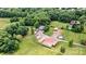 Aerial view of estate surrounded by many trees including the pool, home, and outbuildings at 3724 County Home Rd, Conover, NC 28613