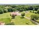 Aerial view of the property showcasing a large metal building, sheds and an American flag at 3724 County Home Rd, Conover, NC 28613