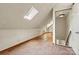 Attic space with neutral walls, tile flooring, skylight, and an open doorway at 3724 County Home Rd, Conover, NC 28613