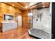 Modern bathroom with glass enclosed shower, vanity, and wood walls at 3724 County Home Rd, Conover, NC 28613