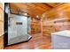 Bathroom with a modern tiled shower, wood paneled walls and ceiling, and wood-look flooring at 3724 County Home Rd, Conover, NC 28613