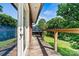 An outdoor wooden deck with a railing overlooking a lush green lawn and shade trees at 3724 County Home Rd, Conover, NC 28613