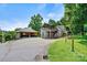Exterior view of a home with a covered porch, attached garage, all surrounded by greenery and mature trees at 3724 County Home Rd, Conover, NC 28613
