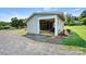 Detached garage with open door and gravel driveway on a grassy, wooded lot at 3724 County Home Rd, Conover, NC 28613