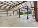 Spacious interior of a metal building with high ceilings and large open doors to a car lift at 3724 County Home Rd, Conover, NC 28613
