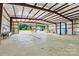 Bright and spacious interior of a metal building, featuring high ceilings, concrete floors, and open bay doors at 3724 County Home Rd, Conover, NC 28613
