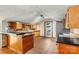 A full view of this kitchen shows a bar top counter, oak cabinetry and tile floors at 3724 County Home Rd, Conover, NC 28613