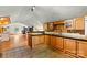 This kitchen is equipped with oak cabinetry, dark counters and tile flooring at 3724 County Home Rd, Conover, NC 28613