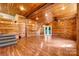 Open living area featuring wood walls and ceiling, hardwood floors, and natural light at 3724 County Home Rd, Conover, NC 28613