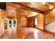 Open living area featuring wood walls and ceiling, hardwood floors, and natural light at 3724 County Home Rd, Conover, NC 28613