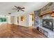 Living room with hardwood floors and a floor-to-ceiling stone fireplace with wood mantle at 3724 County Home Rd, Conover, NC 28613