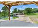 View of the pool from a shaded structure, overlooking the house and wooded land at 3724 County Home Rd, Conover, NC 28613
