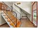 A wooden staircase with iron railing leads up to a hallway and additional rooms at 3724 County Home Rd, Conover, NC 28613