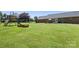 Expansive backyard, showcasing the green lawn and an inviting patio area and play set at 3906 Brickfield St, Hickory, NC 28602