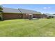 Brick home featuring a spacious backyard, patio, and well-maintained lawn at 3906 Brickfield St, Hickory, NC 28602