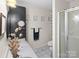 Bathroom with a framed mirror over a single sink vanity, updated fixtures, and tiled floor at 3906 Brickfield St, Hickory, NC 28602