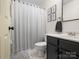 Cozy bathroom featuring a vanity, toilet, shower with curtain, and tasteful decorative elements at 3906 Brickfield St, Hickory, NC 28602