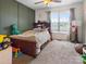 Bedroom featuring a full-sized bed, a ceiling fan and a large window at 3906 Brickfield St, Hickory, NC 28602
