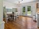 Cozy dining area with hardwood floors, a charming chandelier, and French doors to the backyard at 3906 Brickfield St, Hickory, NC 28602