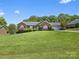 Charming brick home with a well-manicured lawn and mature landscaping, perfect for outdoor enjoyment at 3906 Brickfield St, Hickory, NC 28602