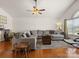 Comfortable living room with a vaulted ceiling, ceiling fan, and natural light from a large window at 3906 Brickfield St, Hickory, NC 28602