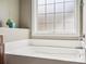 A view of a bright bathroom, featuring a soaking tub beneath a window, and chrome hardware at 4090 Sunset Dr, Rock Hill, SC 29732