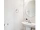 Clean half bathroom with a pedestal sink, round mirror, and neutral decor at 4090 Sunset Dr, Rock Hill, SC 29732