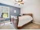 Cozy bedroom with a ceiling fan, neutral carpet, and large window to enhance the space at 4090 Sunset Dr, Rock Hill, SC 29732