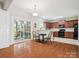 Open dining area with hardwood floors, sliding door access to the deck, and kitchen view at 4090 Sunset Dr, Rock Hill, SC 29732