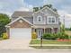 Charming two-story home features a manicured lawn and a stone and gray shingle facade at 4090 Sunset Dr, Rock Hill, SC 29732