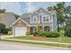 Charming two-story home features a manicured lawn and a stone and gray shingle facade at 4090 Sunset Dr, Rock Hill, SC 29732