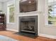 Close-up of the living room fireplace with hardwood floors and bright windows nearby at 4090 Sunset Dr, Rock Hill, SC 29732