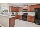 Well-lit kitchen features dark wood cabinets, granite countertops, and stainless steel appliances at 4090 Sunset Dr, Rock Hill, SC 29732