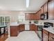 Well-lit kitchen features dark wood cabinets, granite countertops, and stainless steel appliances at 4090 Sunset Dr, Rock Hill, SC 29732