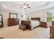 Spacious main bedroom featuring a tray ceiling, neutral carpet, and beautiful wood furniture at 4090 Sunset Dr, Rock Hill, SC 29732