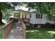 Exterior view featuring a wooden ramp to deck and partially covered patio at 4143 E Maiden Rd, Maiden, NC 28650
