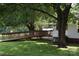 Backyard featuring a wooden ramp, patio, covered area, and shade trees at 4143 E Maiden Rd, Maiden, NC 28650