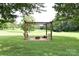 Backyard seating area featuring outdoor swings, pergola, fire pit, and ample space at 4143 E Maiden Rd, Maiden, NC 28650