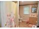 Well-lit bathroom featuring a vanity, shower, and window for natural light at 4143 E Maiden Rd, Maiden, NC 28650