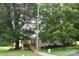 Ranch style home with charming ramp access, nestled among mature trees and a green lawn at 4143 E Maiden Rd, Maiden, NC 28650