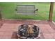 Fire pit with a rustic swing bench and brick paving stones, perfect for outdoor relaxing at 4143 E Maiden Rd, Maiden, NC 28650