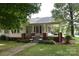 Charming home with covered porch and swing, landscaped yard, and inviting walkway at 4143 E Maiden Rd, Maiden, NC 28650
