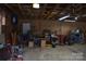 Large garage interior featuring an exposed ceiling, and workbench areas for hobbies and projects at 4143 E Maiden Rd, Maiden, NC 28650